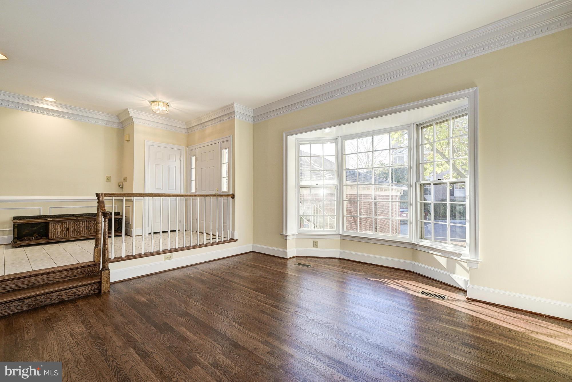 8023 Rising Ridge Road Bethesda, MD 20817 - Photo 3 of 30 a view of an empty room with wooden floor and a window