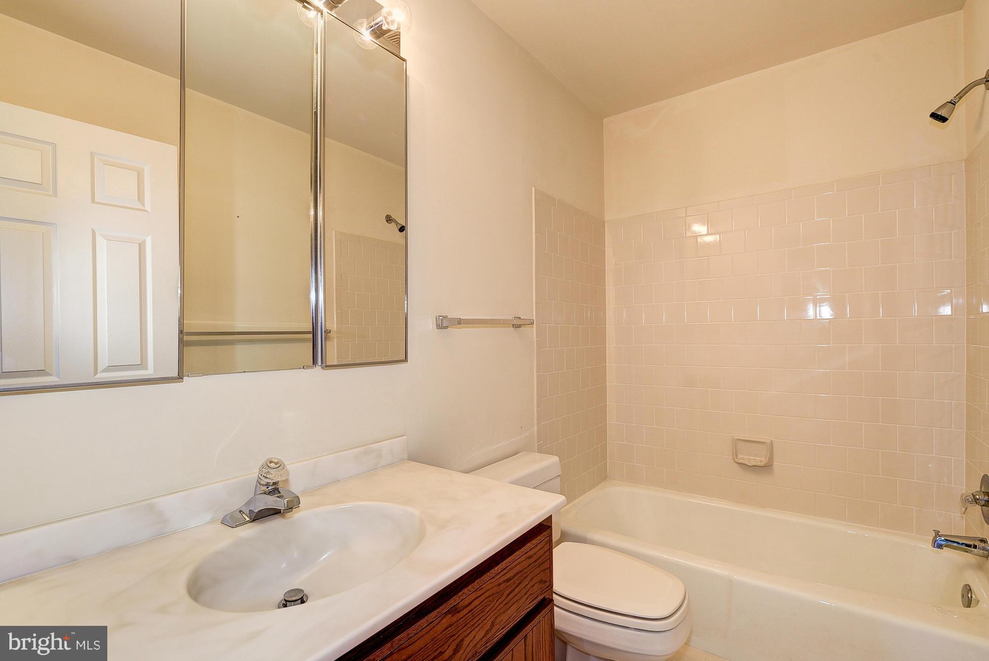 8023 Rising Ridge Road Bethesda, MD 20817 - Photo 21 of 30 a bathroom with a sink a toilet and shower
