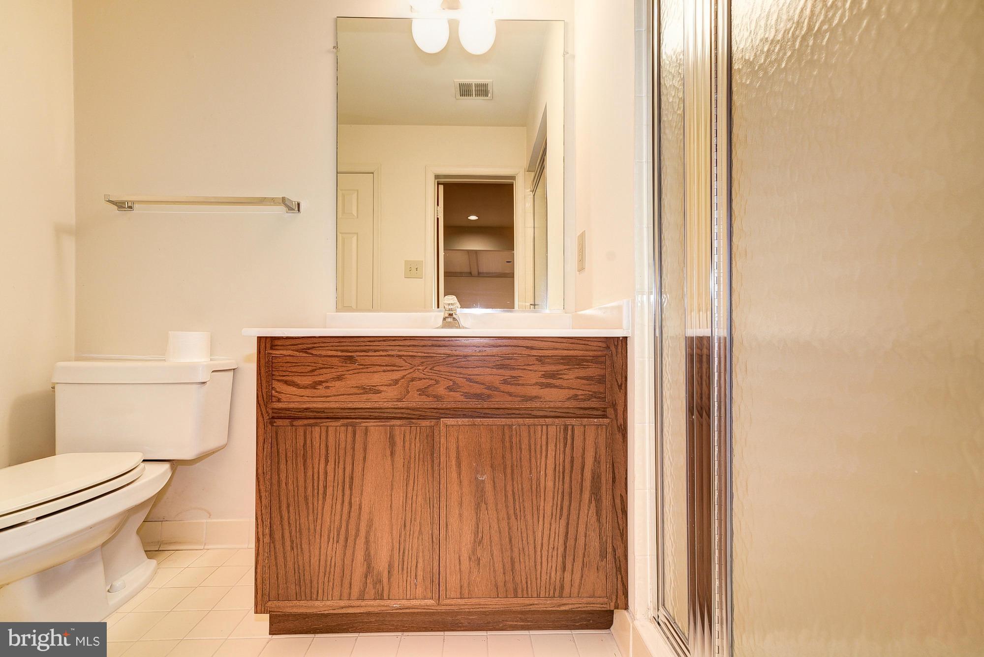 8023 Rising Ridge Road Bethesda, MD 20817 - Photo 26 of 30 a bathroom with a toilet and a shower curtain