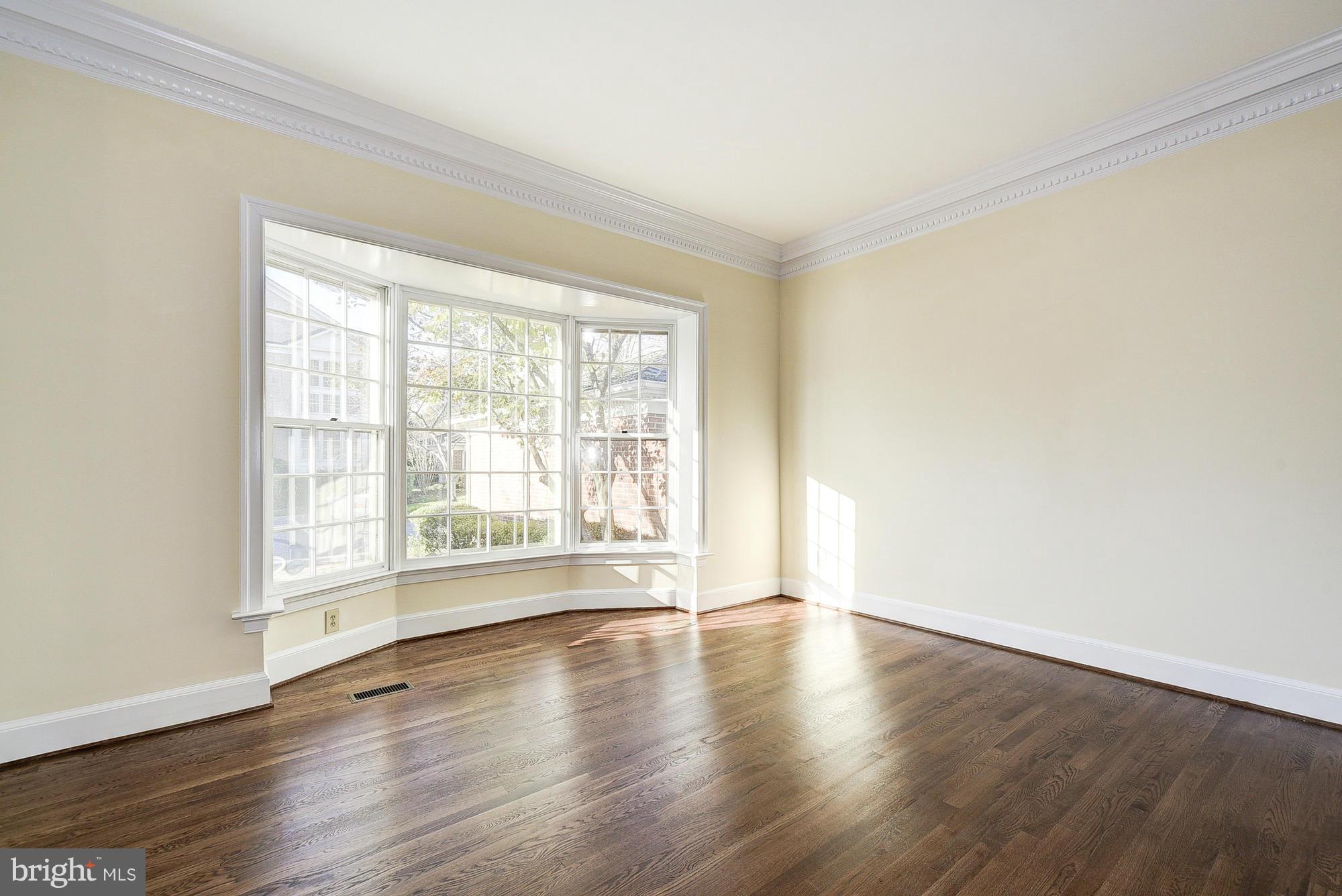 8023 Rising Ridge Road Bethesda, MD 20817 - Photo 4 of 30 a view of an empty room with wooden floor and a window