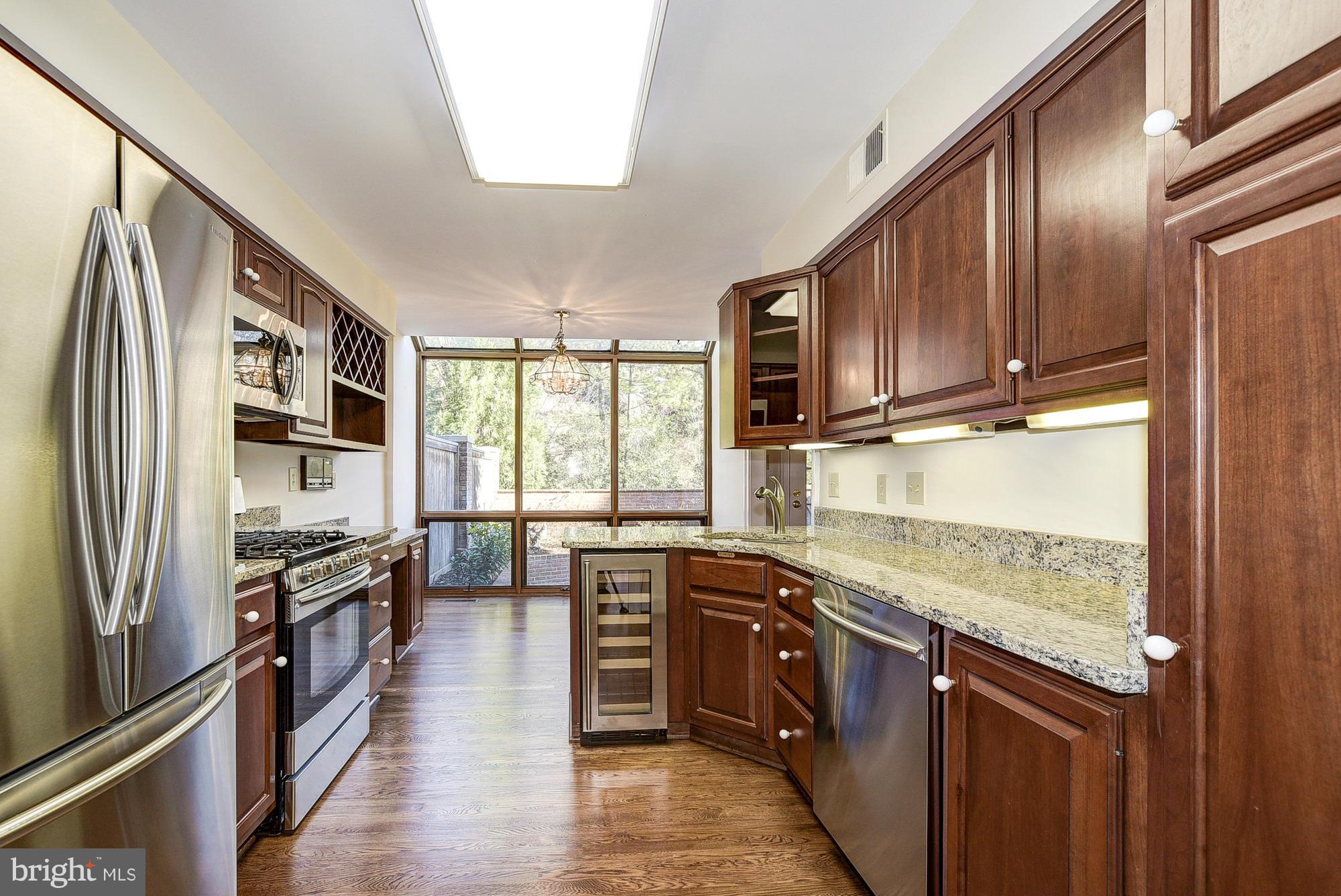 8023 Rising Ridge Road Bethesda, MD 20817 - Photo 7 of 30 a kitchen with stainless steel appliances granite countertop a stove top oven a sink and dishwasher