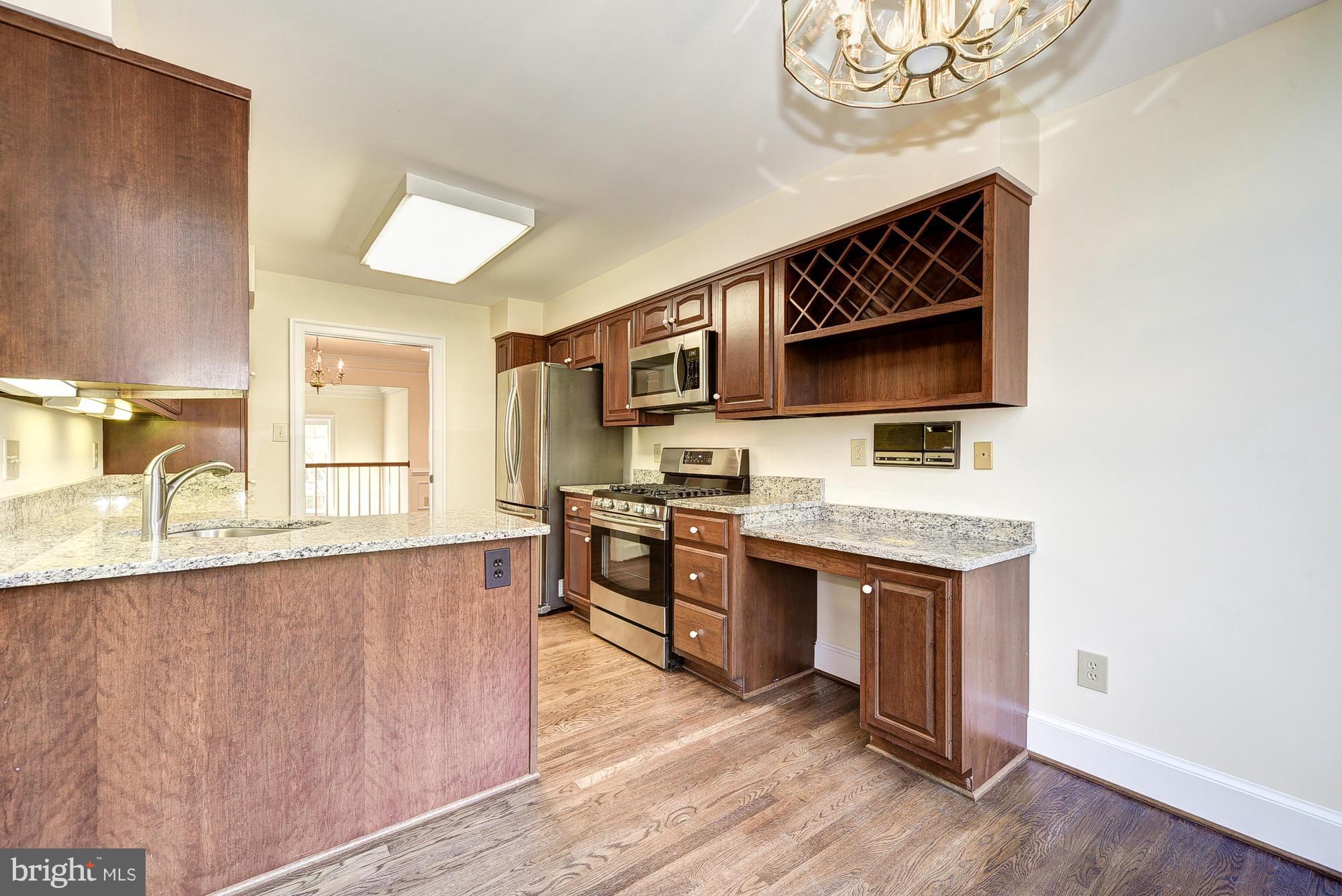 8023 Rising Ridge Road Bethesda, MD 20817 - Photo 9 of 30 a kitchen with stainless steel appliances granite countertop a stove and a sink
