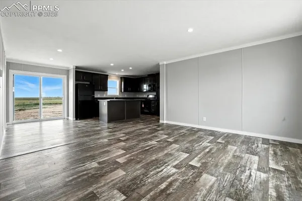 a view of kitchen with refrigerator and window