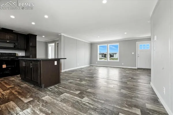 a view of a kitchen with a sink and a refrigerator