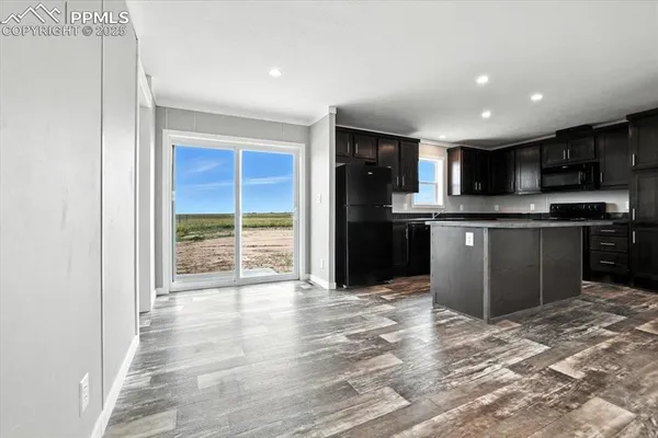 a kitchen with stainless steel appliances granite countertop a refrigerator and a stove top oven