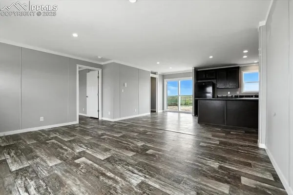 a view of a kitchen with a sink and a refrigerator