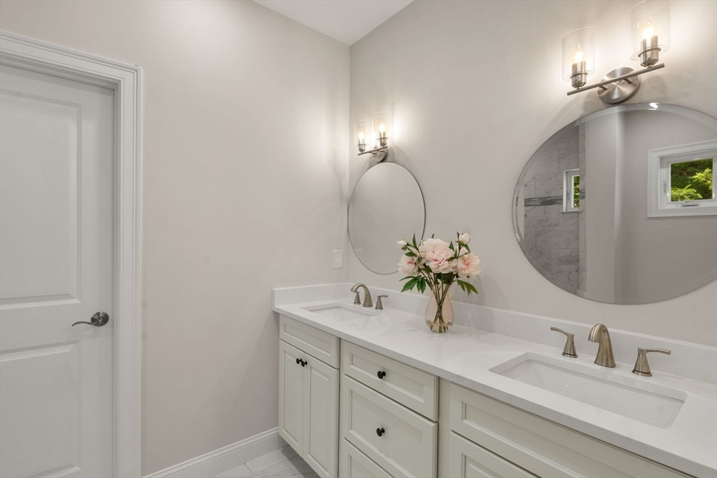 1 Emmeline Path, Unit 1 Wayland, MA 01778 - Photo 12 of 22 a bathroom with double vanity sinks and a mirror