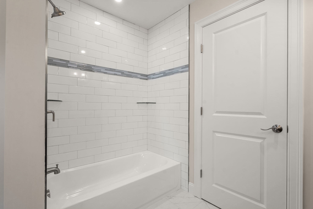 1 Emmeline Path, Unit 1 Wayland, MA 01778 - Photo 17 of 22 a bathroom with a bathtub and a shower