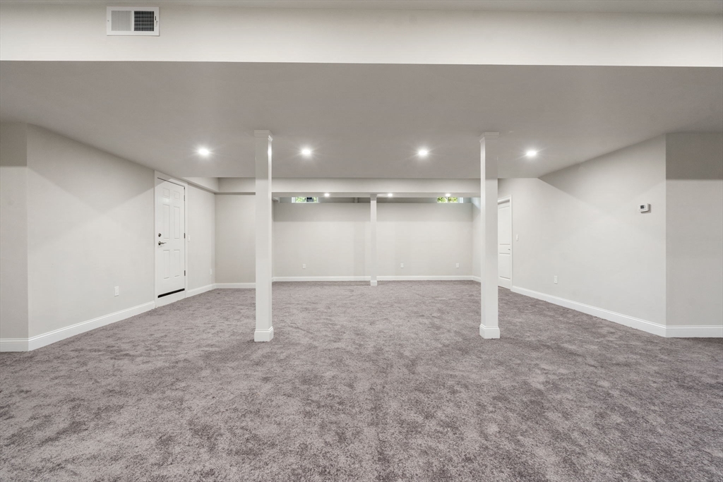 1 Emmeline Path, Unit 1 Wayland, MA 01778 - Photo 18 of 22 an empty room with a natural light