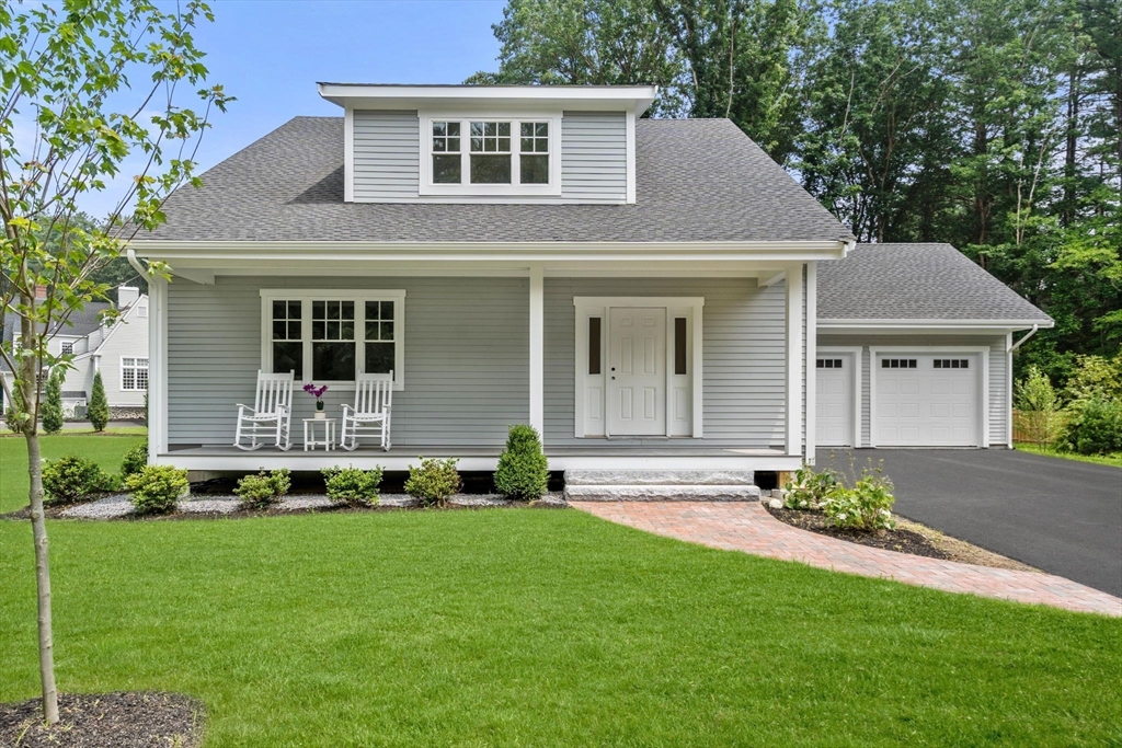 1 Emmeline Path, Unit 1 Wayland, MA 01778 - Photo 2 of 22 a front view of a house with a garden and yard