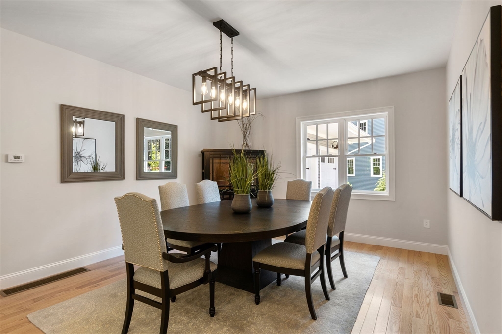 1 Emmeline Path, Unit 1 Wayland, MA 01778 - Photo 10 of 22 a view of a dining room with furniture a chandelier and wooden floor