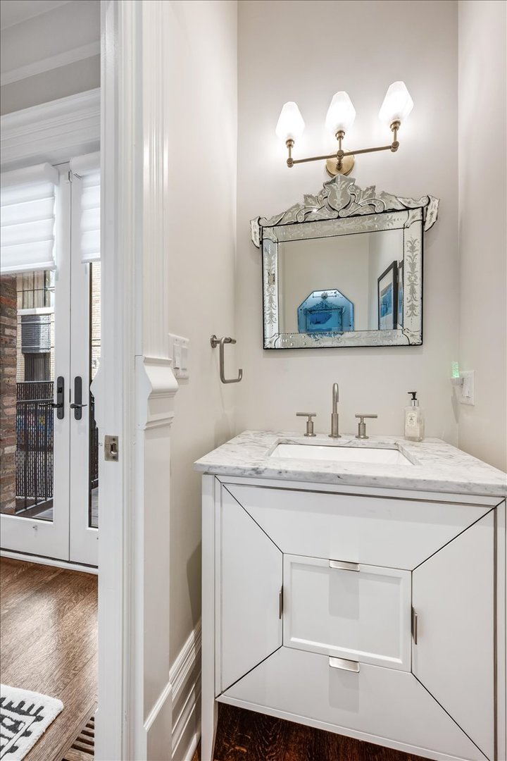 1304 North Ritchie Court Chicago, IL 60610 - Photo 12 of 28 a bathroom with a sink and a mirror