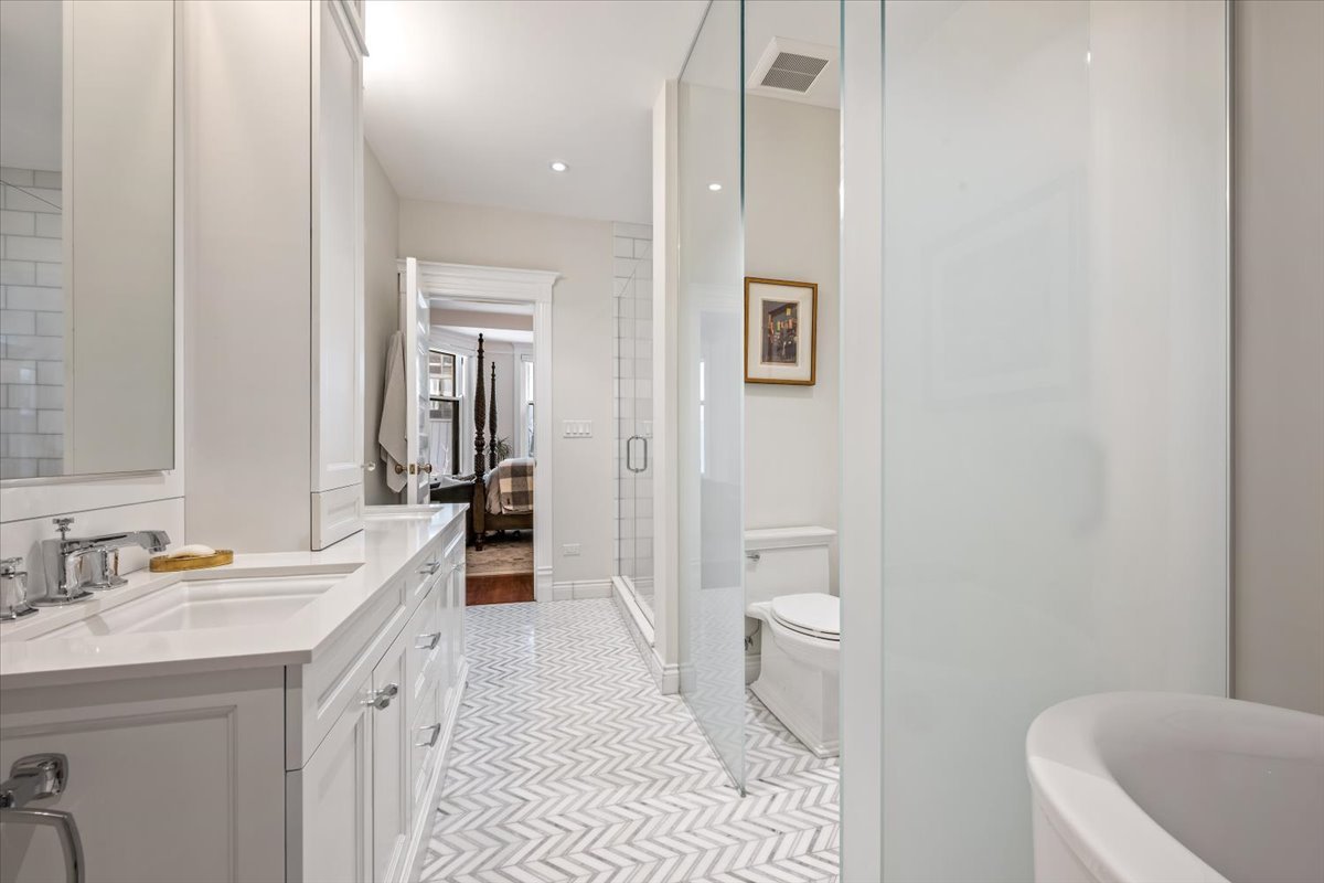 1304 North Ritchie Court Chicago, IL 60610 - Photo 16 of 28 a en suite bathroom with a granite countertop sink a toilet a mirror and shower