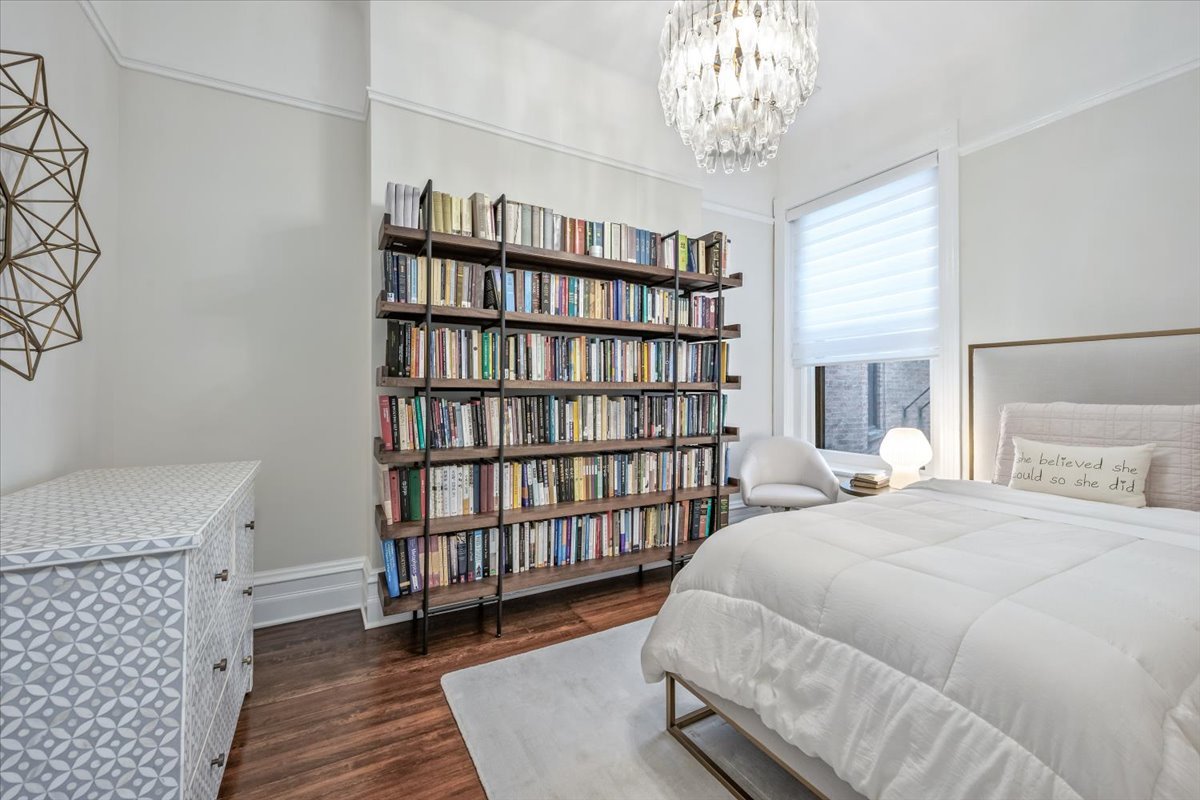 1304 North Ritchie Court Chicago, IL 60610 - Photo 19 of 28 a bedroom with a bed and a book shelf