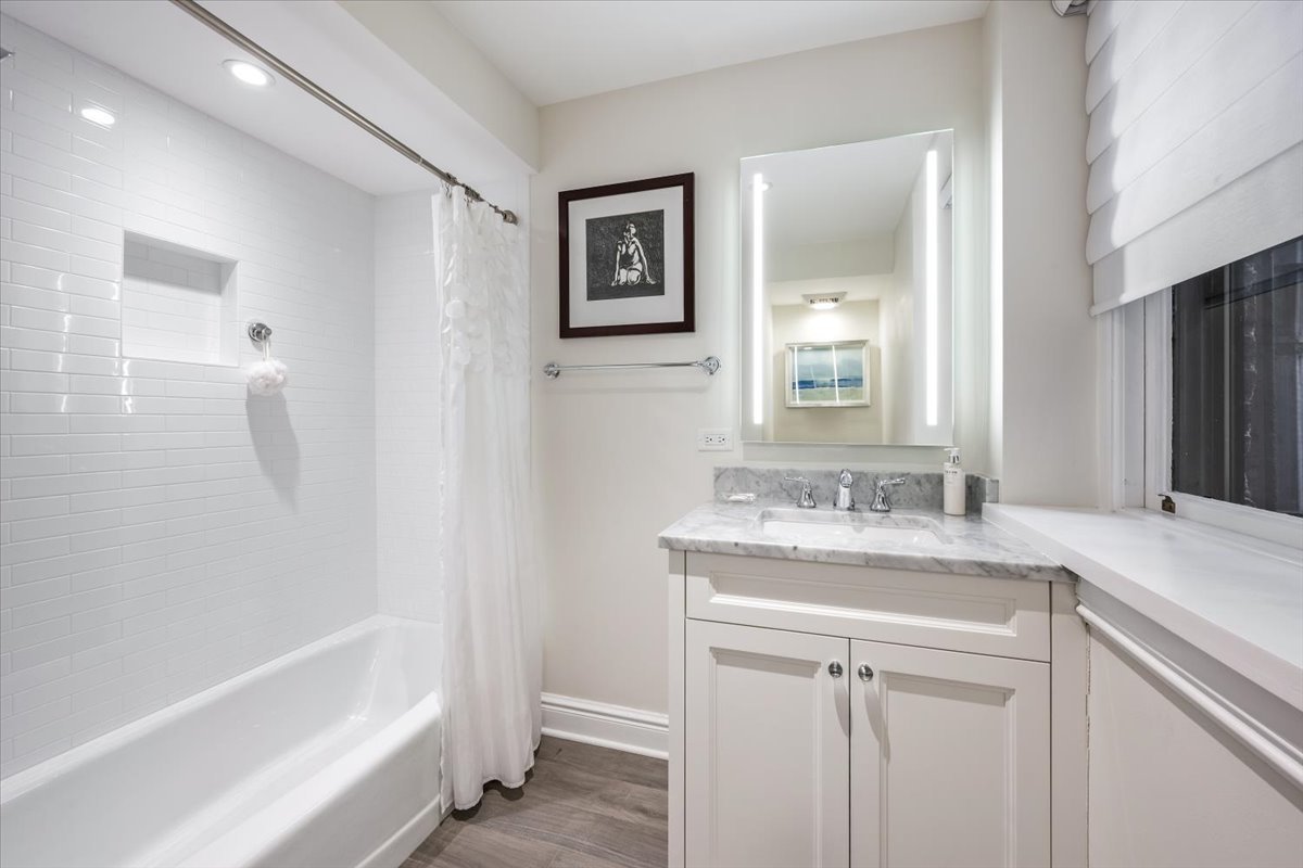 1304 North Ritchie Court Chicago, IL 60610 - Photo 26 of 28 a bathroom with a sink double vanity granite tub and shower