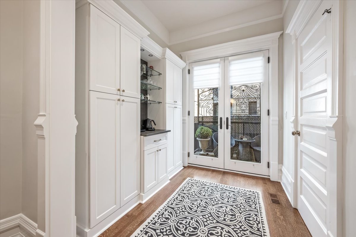 1304 North Ritchie Court Chicago, IL 60610 - Photo 9 of 28 a hallway with white cabinets and wooden floor