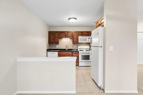 a kitchen with stainless steel appliances a refrigerator and a stove
