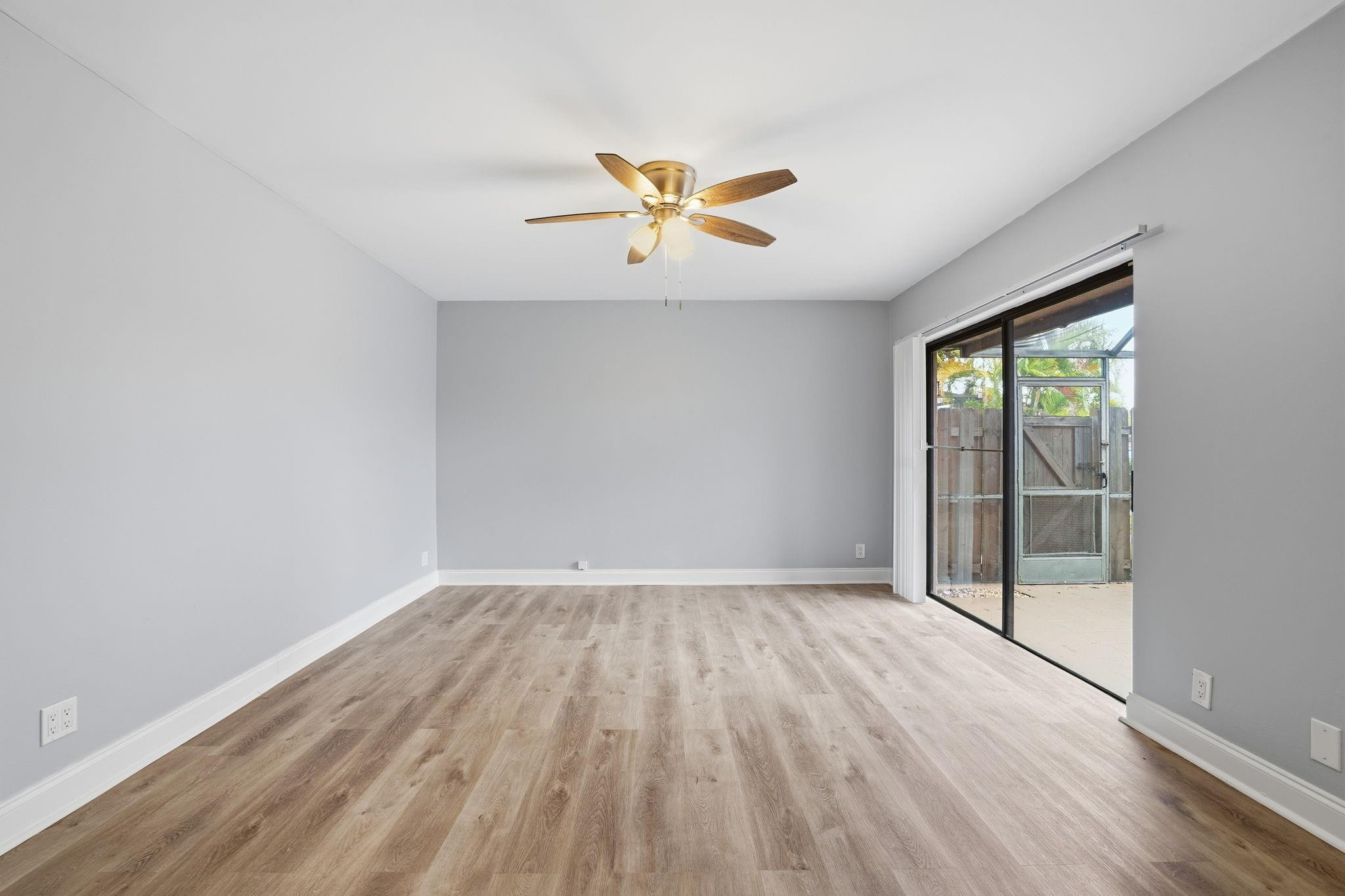 7600 Courtyard Run West Boca Raton, FL 33433 - Photo 12 of 34 an empty room with a window and a ceiling fan