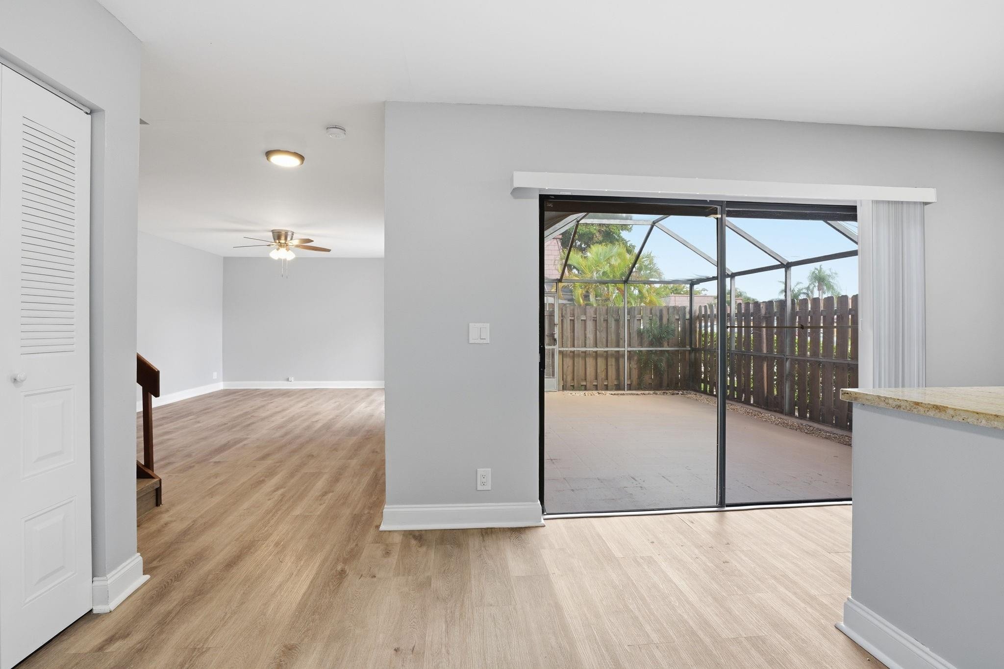7600 Courtyard Run West Boca Raton, FL 33433 - Photo 13 of 34 a view of empty room with wooden floor and fan