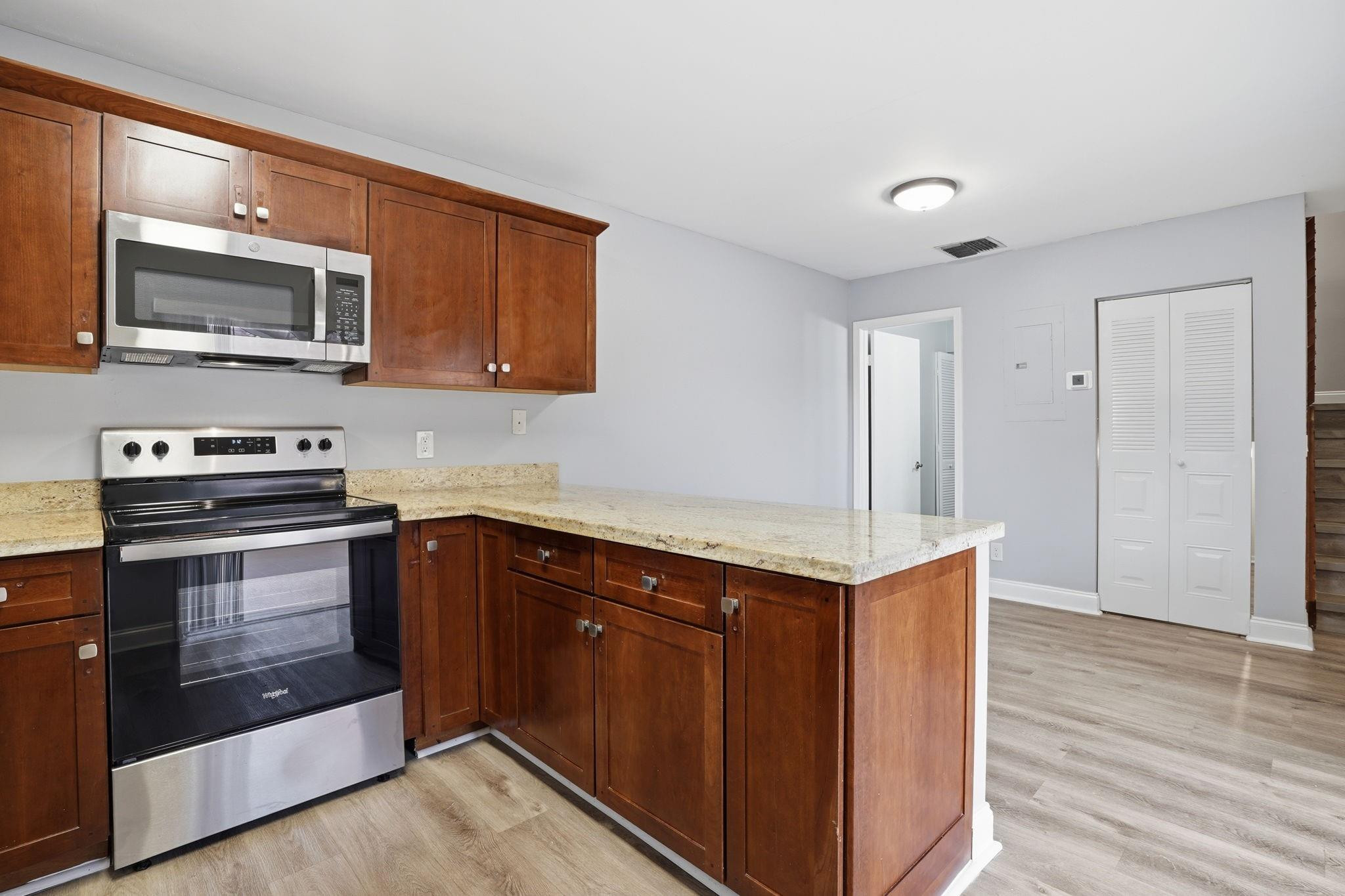 7600 Courtyard Run West Boca Raton, FL 33433 - Photo 17 of 34 a kitchen with stainless steel appliances granite countertop a stove and a microwave