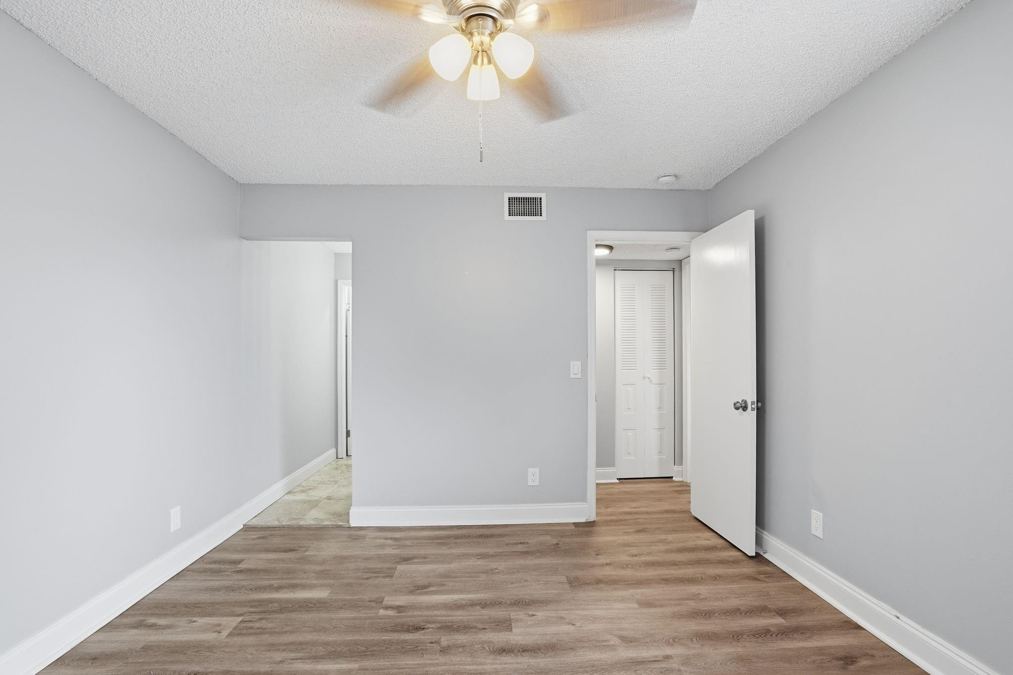7600 Courtyard Run West Boca Raton, FL 33433 - Photo 21 of 34 a view of an empty room with wooden floor