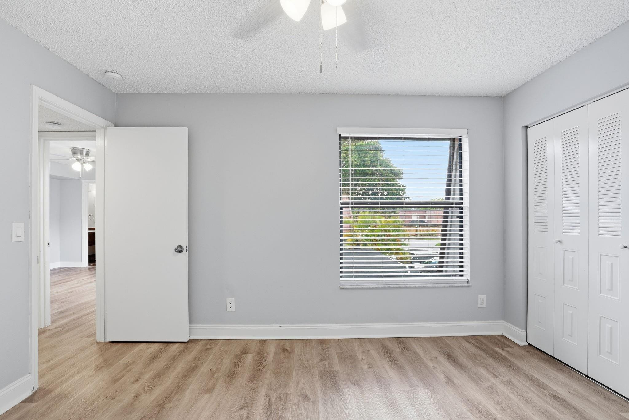 7600 Courtyard Run West Boca Raton, FL 33433 - Photo 22 of 34 a view of an empty room with wooden floor and a window