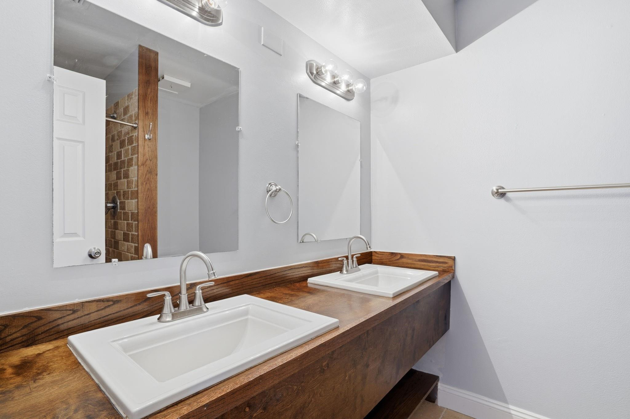 7600 Courtyard Run West Boca Raton, FL 33433 - Photo 25 of 34 a bathroom with a sink and a mirror