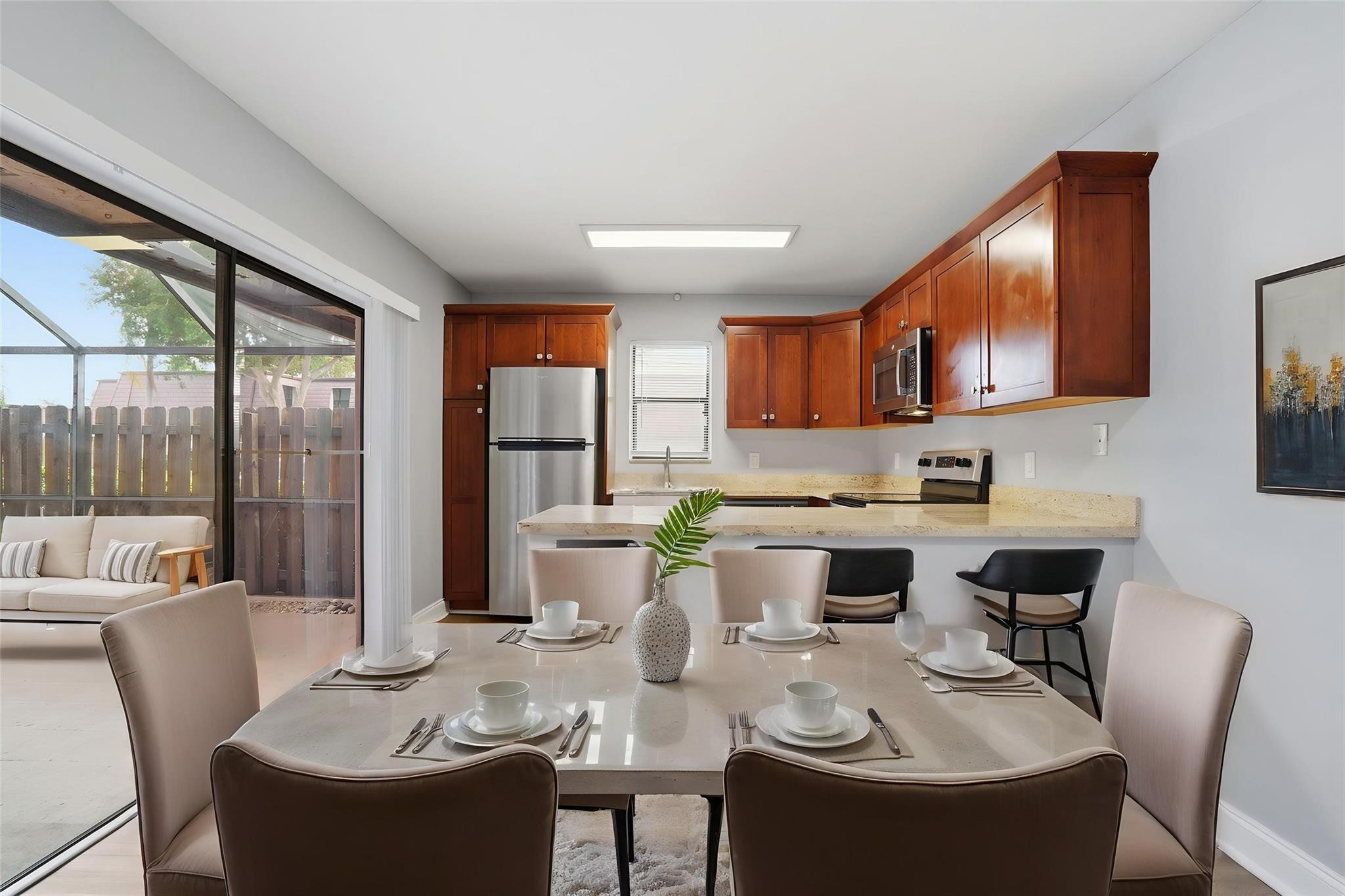 7600 Courtyard Run West Boca Raton, FL 33433 - Photo 5 of 34 a dining room with furniture a large window and kitchen view