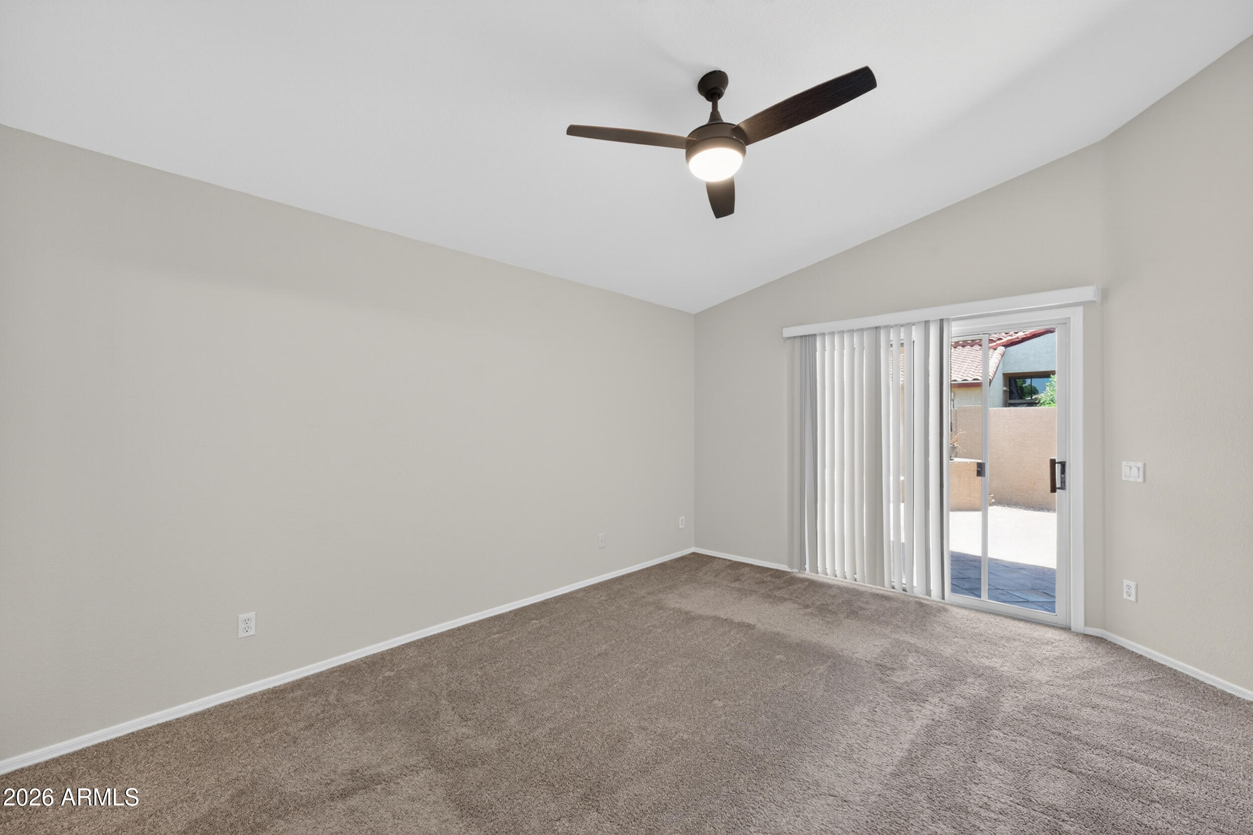 4729 West Monterey Street Chandler, AZ 85226 - Photo 4 of 50 an empty room with a ceiling fan and a large window