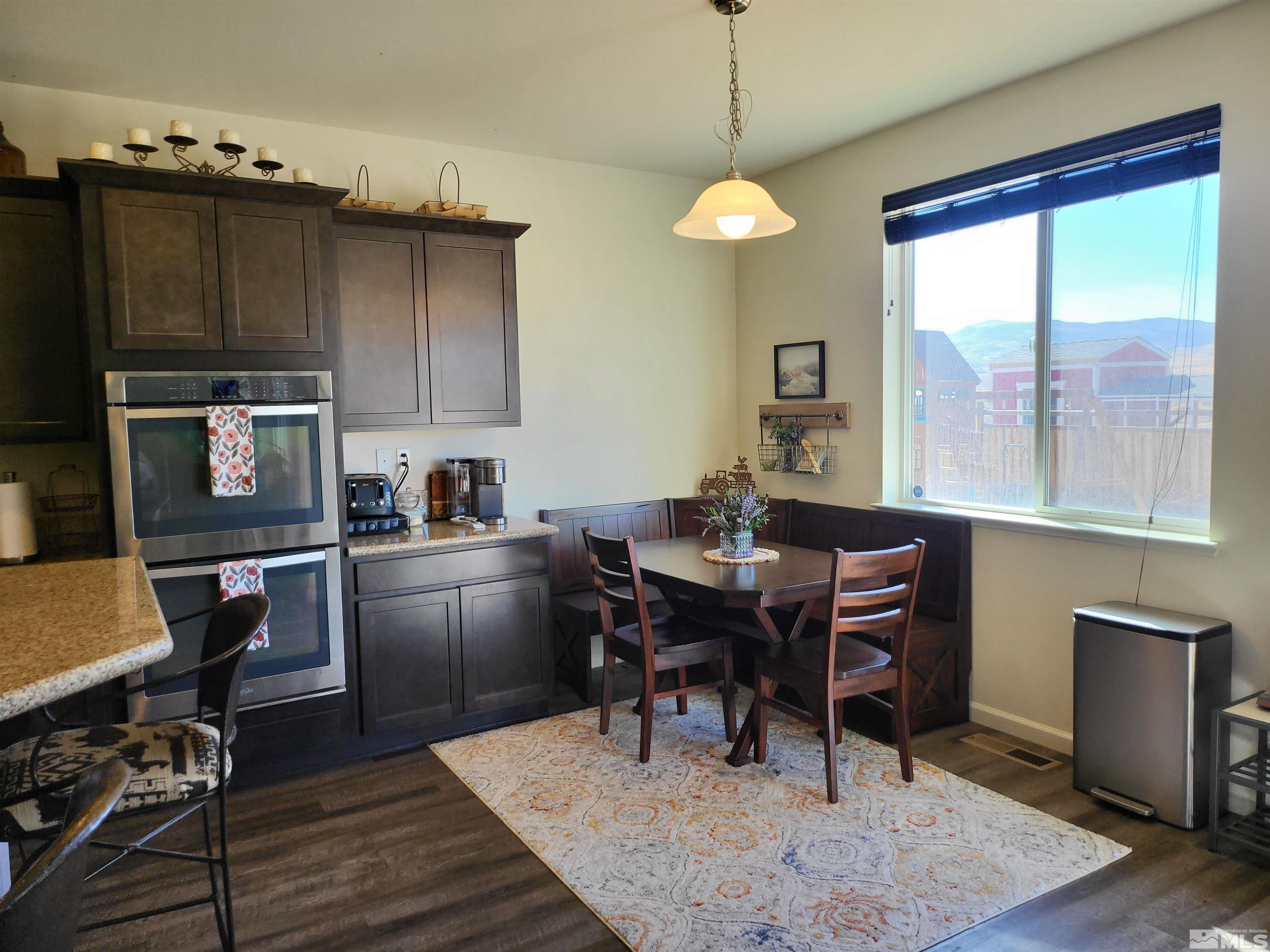 200 Pinto Ranch Court Reno, NV 89510 - Photo 11 of 37 a kitchen with a dining table chairs and a refrigerator
