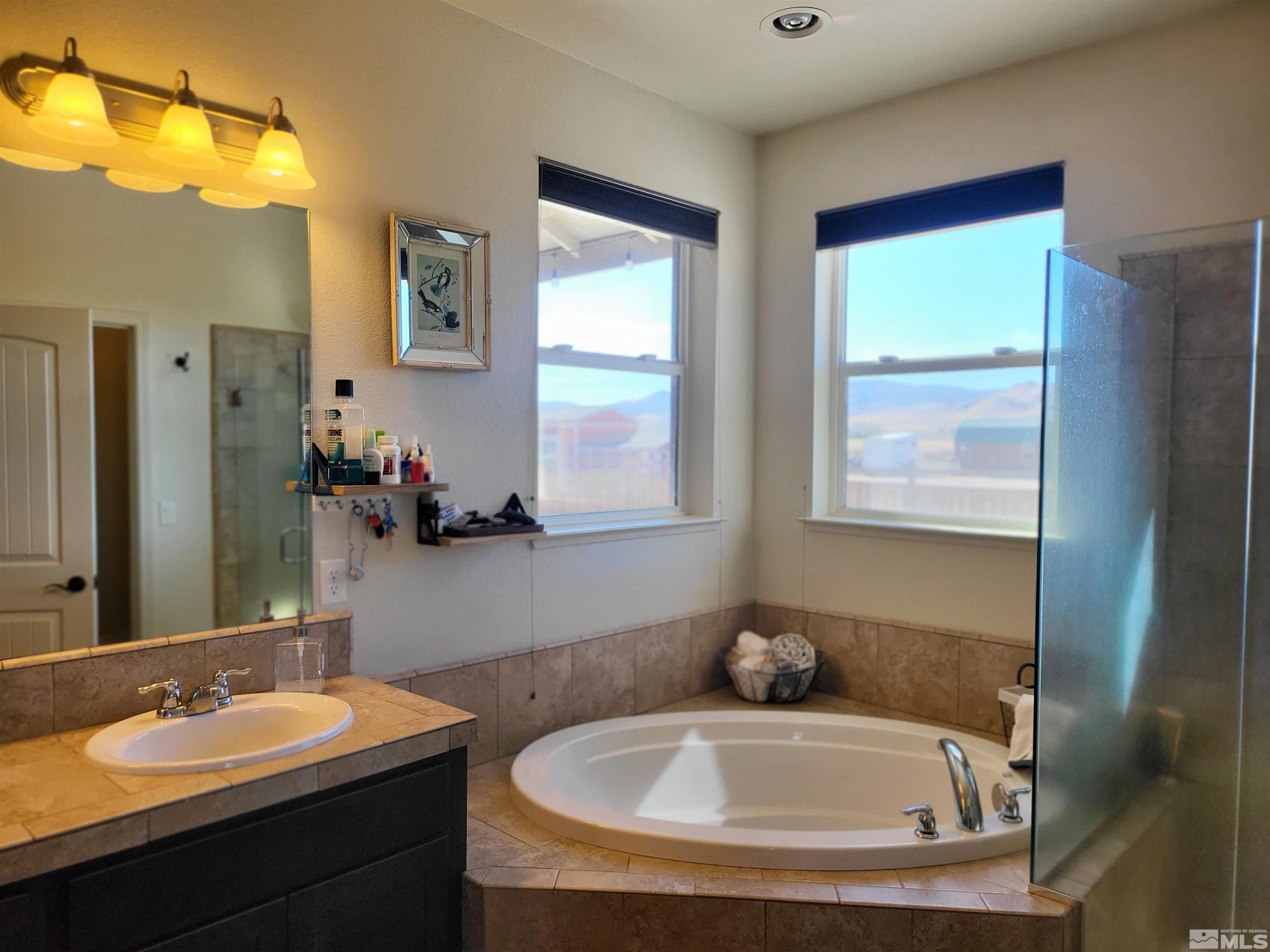 200 Pinto Ranch Court Reno, NV 89510 - Photo 16 of 37 a bathroom with a tub sink and mirror