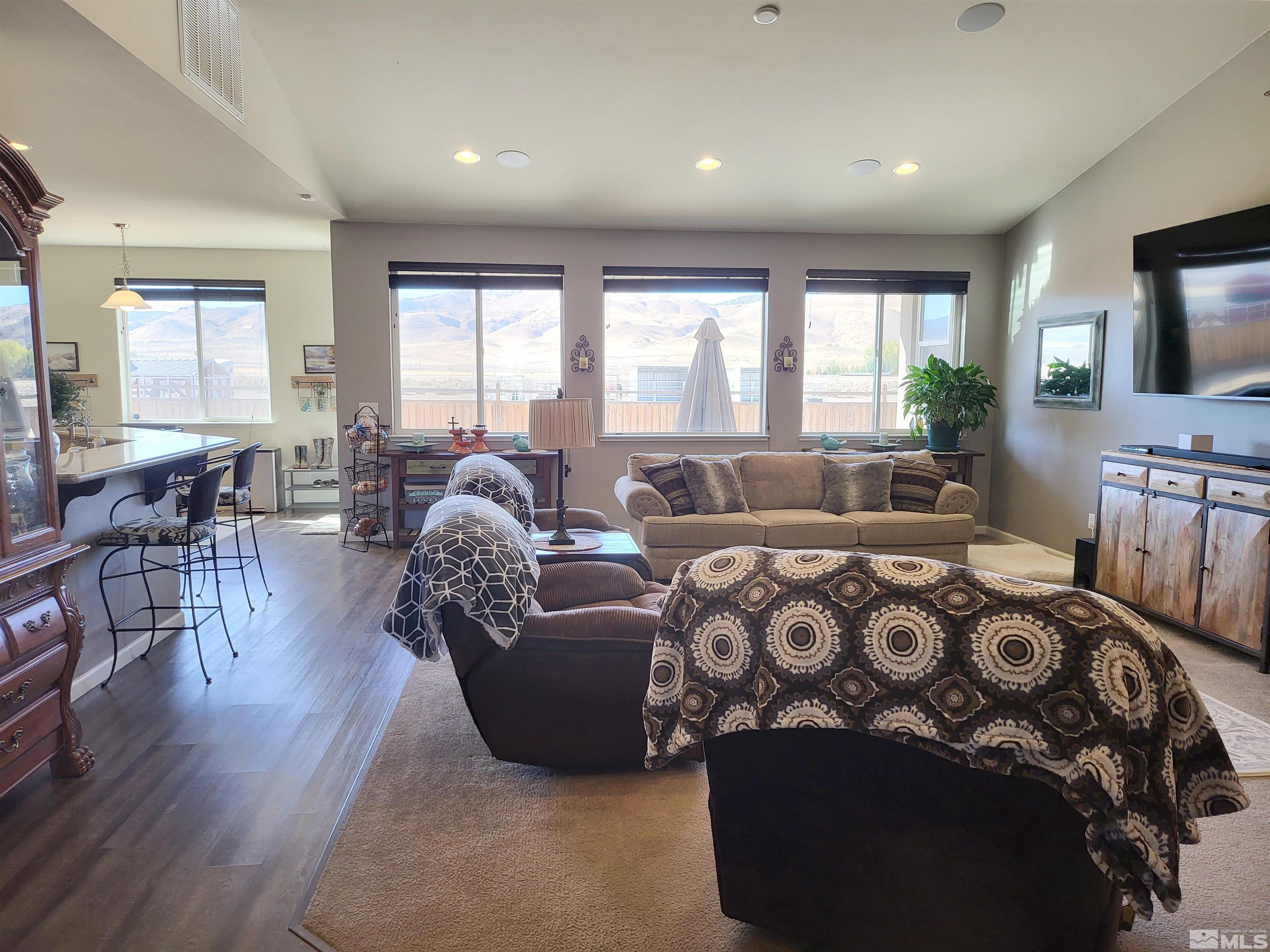 200 Pinto Ranch Court Reno, NV 89510 - Photo 6 of 37 a spacious bedroom with a balcony a bed a couch and dresser