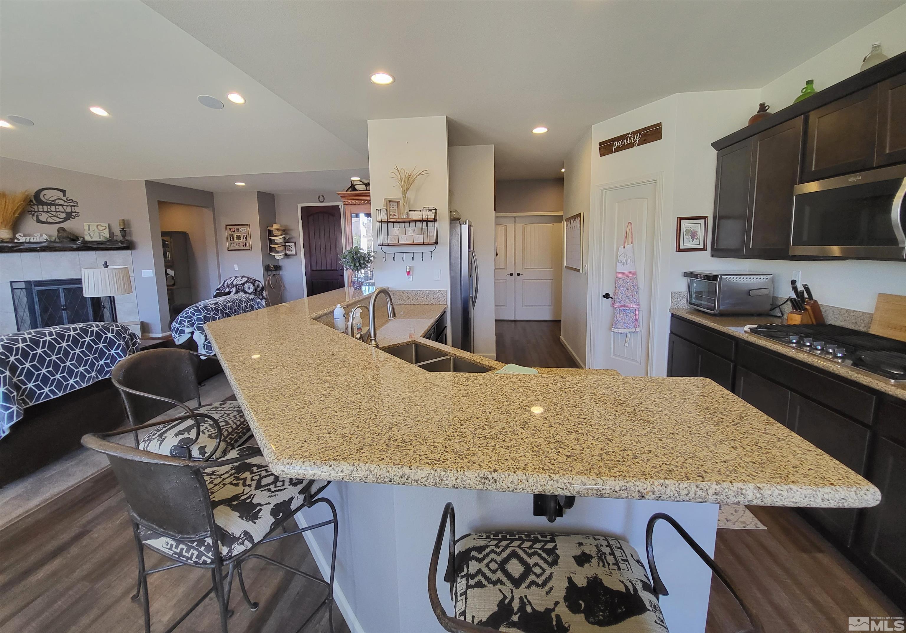 200 Pinto Ranch Court Reno, NV 89510 - Photo 10 of 37 a living room with stainless steel appliances kitchen island granite countertop furniture and kitchen view