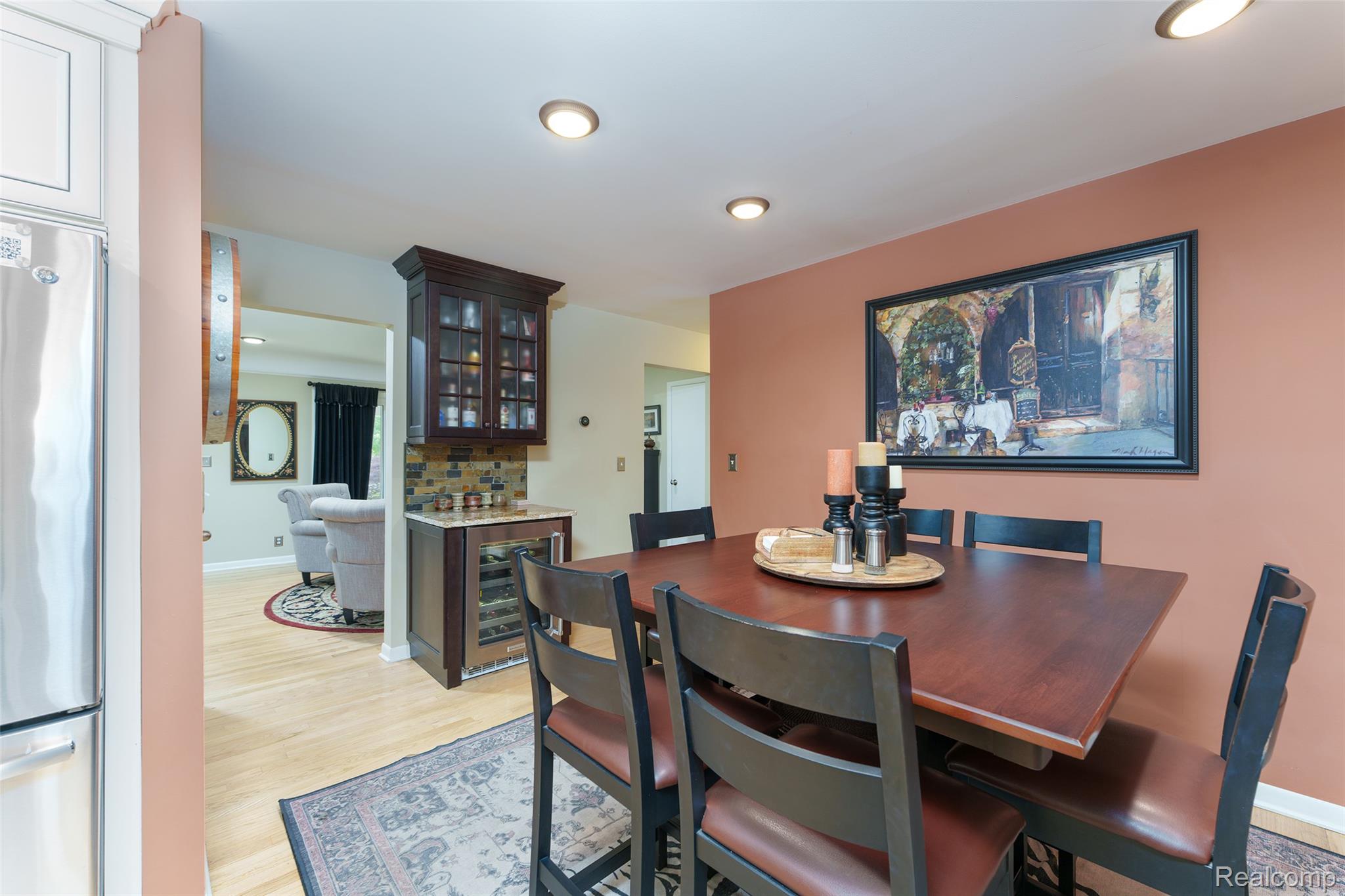 2172 Devonshire Road Bloomfield Hills, MI 48302 - Photo 10 of 45 Dining area featuring wood flooring, recessed lighting, and a built-in beverage center with glass-front cabinetry and a wine refrigerator