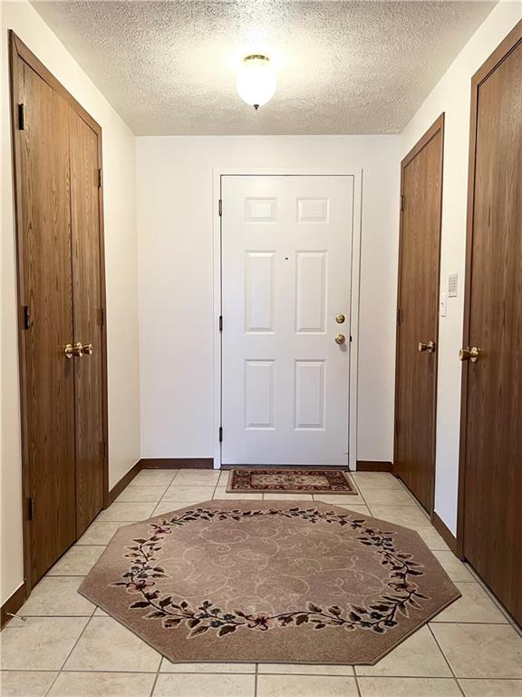 2850 Edgecliff Road, Unit 35 Lower Burrell, PA 15068 - Photo 3 of 27 Ceramic flooring and two closets. Entry into laundry area.