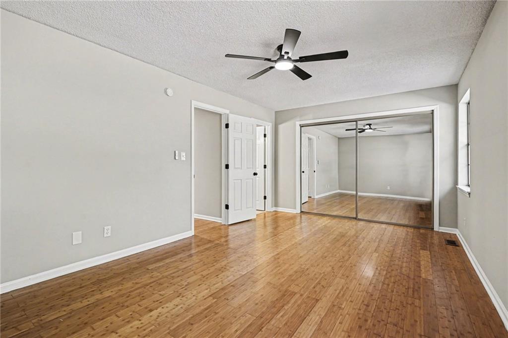 6052 WinterGreen Road Northwest Norcross, GA 30093 - Photo 17 of 24 a view of empty room with wooden floor and fan