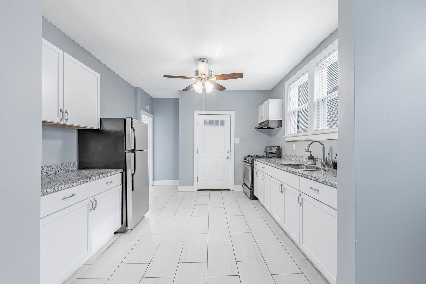 7729 South Laflin Street Chicago, IL 60620 - Photo 11 of 44 a kitchen with stainless steel appliances granite countertop a stove cabinets and a refrigerator