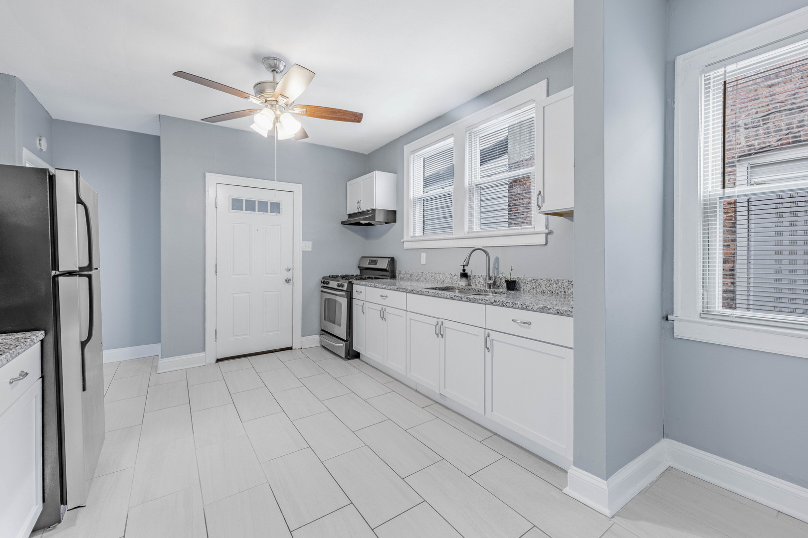 7729 South Laflin Street Chicago, IL 60620 - Photo 12 of 44 a large white kitchen with cabinets