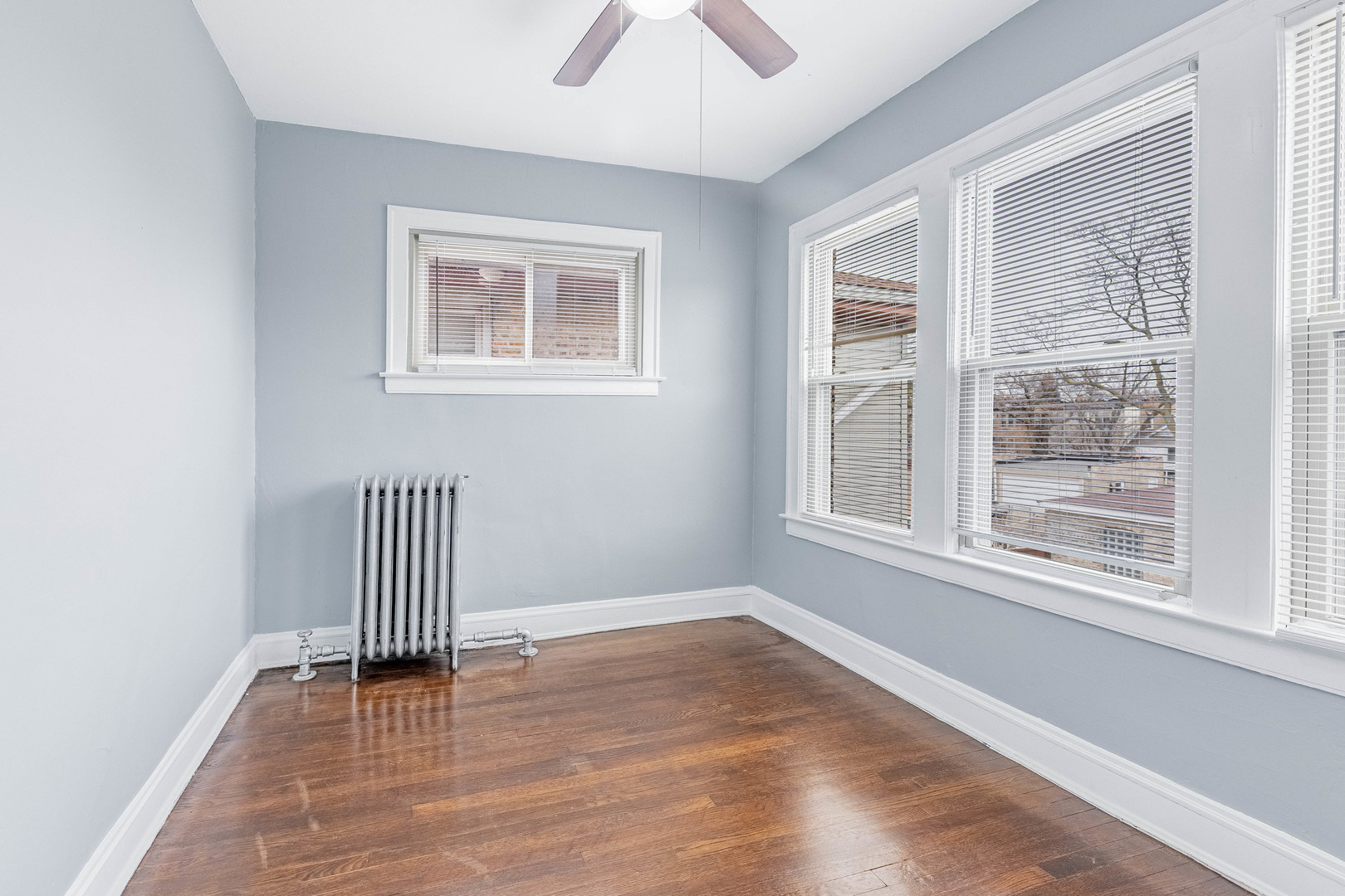 7729 South Laflin Street Chicago, IL 60620 - Photo 15 of 44 a view of empty room with wooden floor and fan