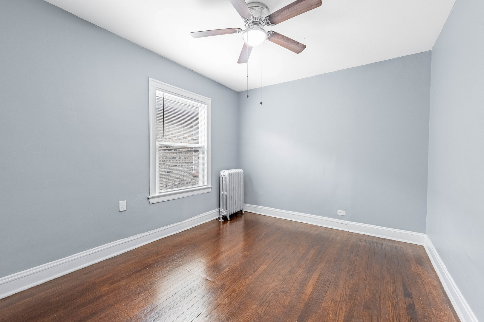 7729 South Laflin Street Chicago, IL 60620 - Photo 18 of 44 a view of room with window hardwood floor and ceiling fan