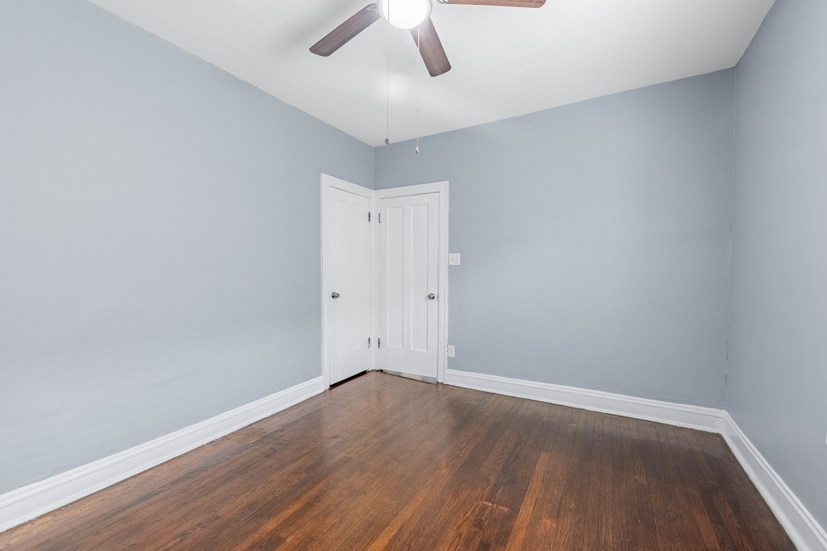7729 South Laflin Street Chicago, IL 60620 - Photo 24 of 44 an empty room with wooden floor and windows