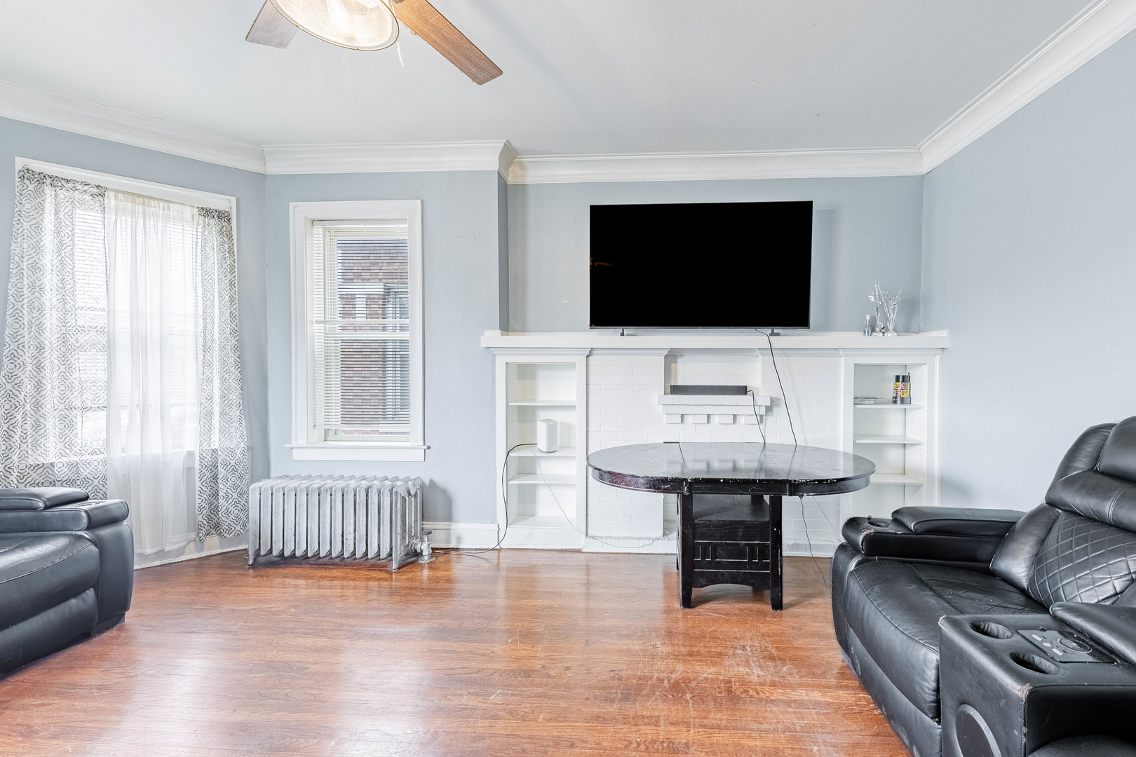 7729 South Laflin Street Chicago, IL 60620 - Photo 26 of 44 a living room with furniture and a flat screen tv