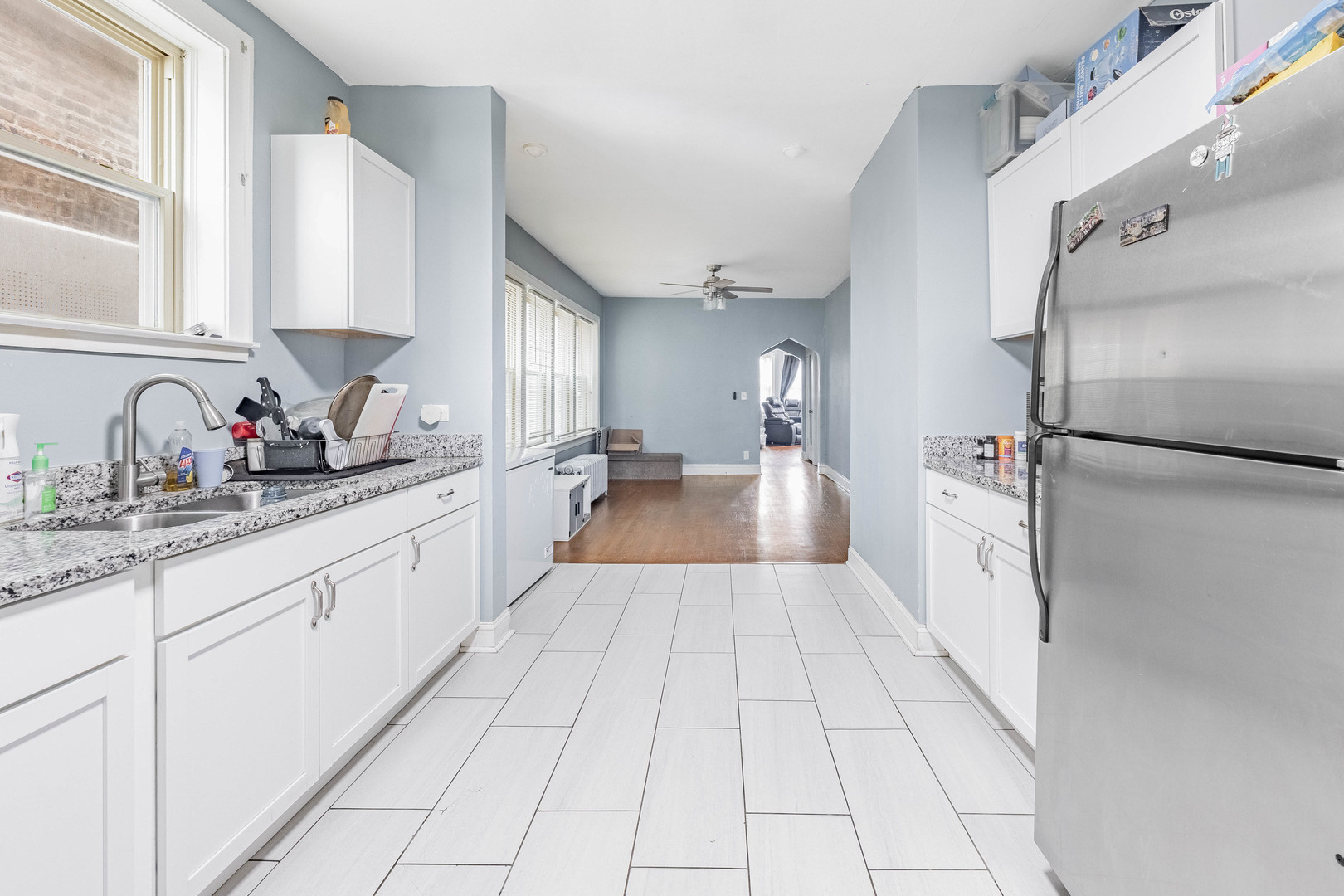 7729 South Laflin Street Chicago, IL 60620 - Photo 35 of 44 a large white kitchen with a sink and refrigerator