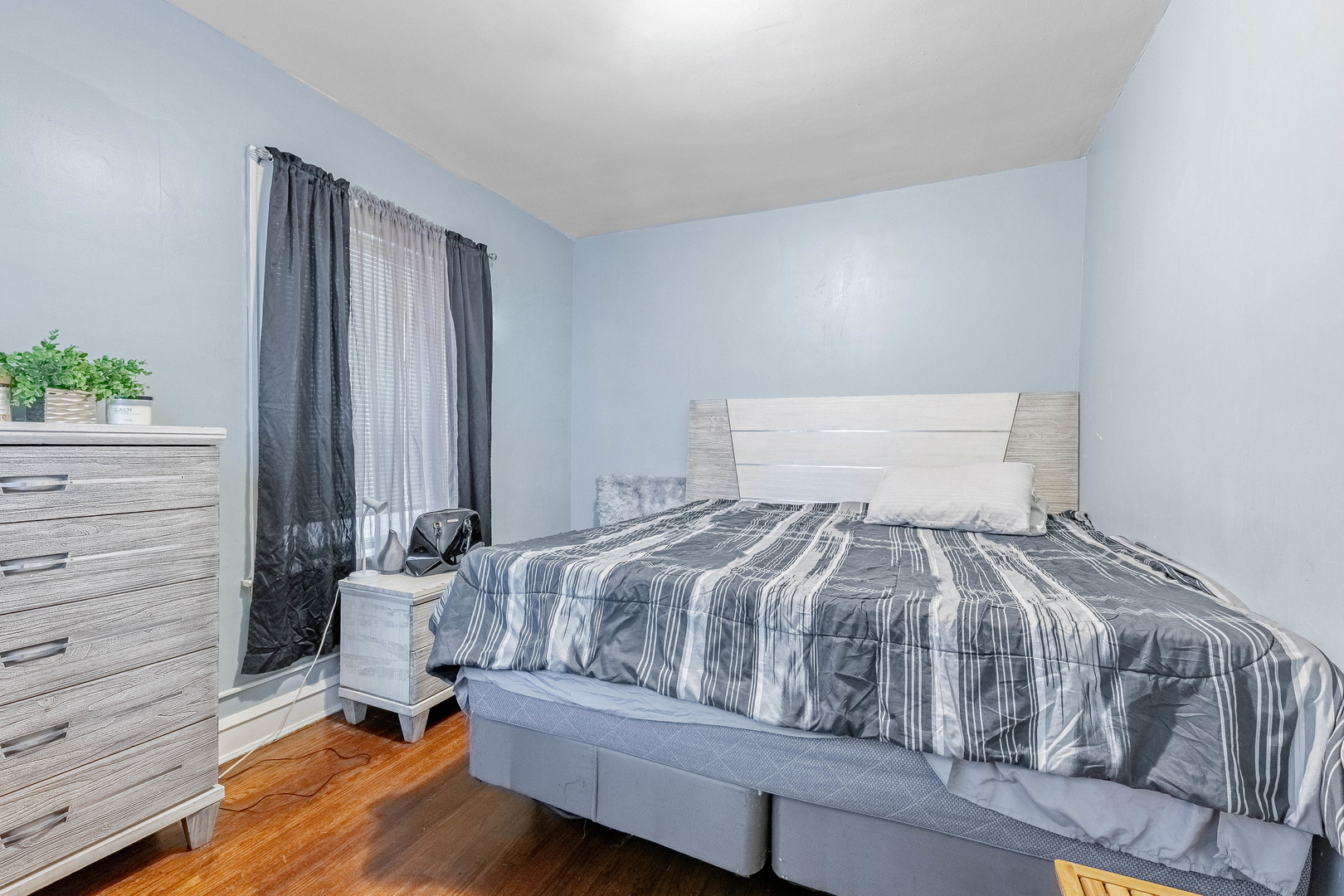 7729 South Laflin Street Chicago, IL 60620 - Photo 38 of 44 a bedroom with a bed and a dresser