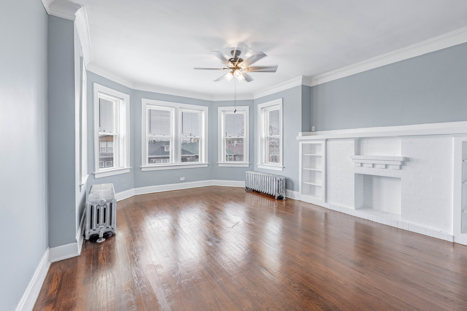7729 South Laflin Street Chicago, IL 60620 - Photo 4 of 44 a view of an empty room with wooden floor and a window