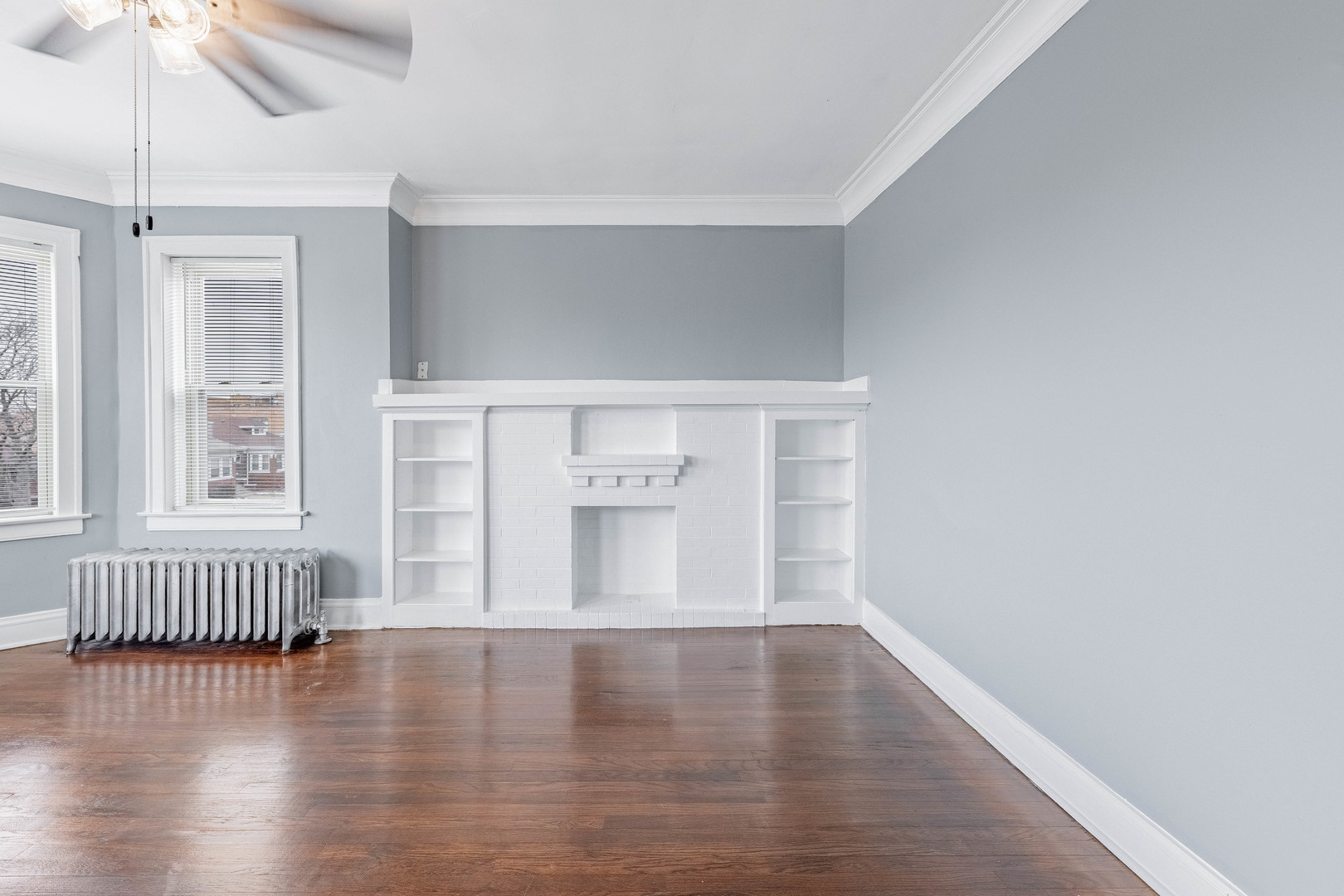 7729 South Laflin Street Chicago, IL 60620 - Photo 6 of 44 a view of an empty room with wooden floor and a window