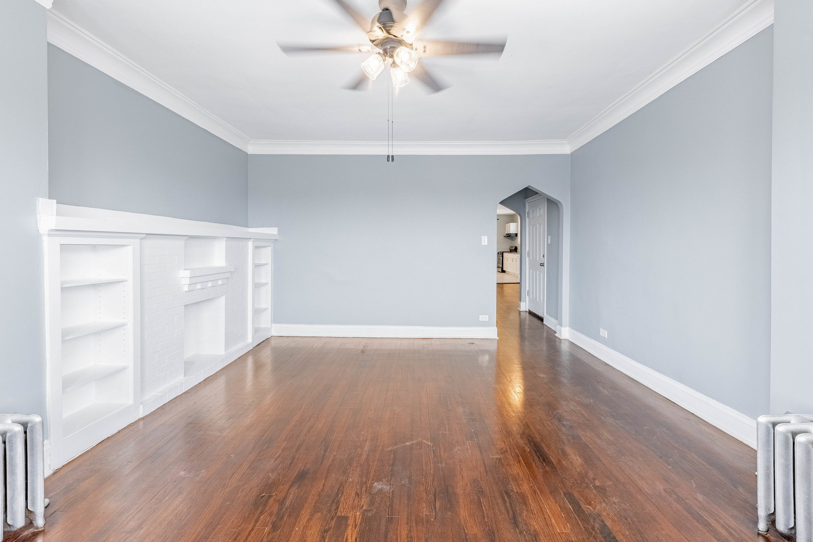 7729 South Laflin Street Chicago, IL 60620 - Photo 7 of 44 a view of empty room with wooden floor and fan