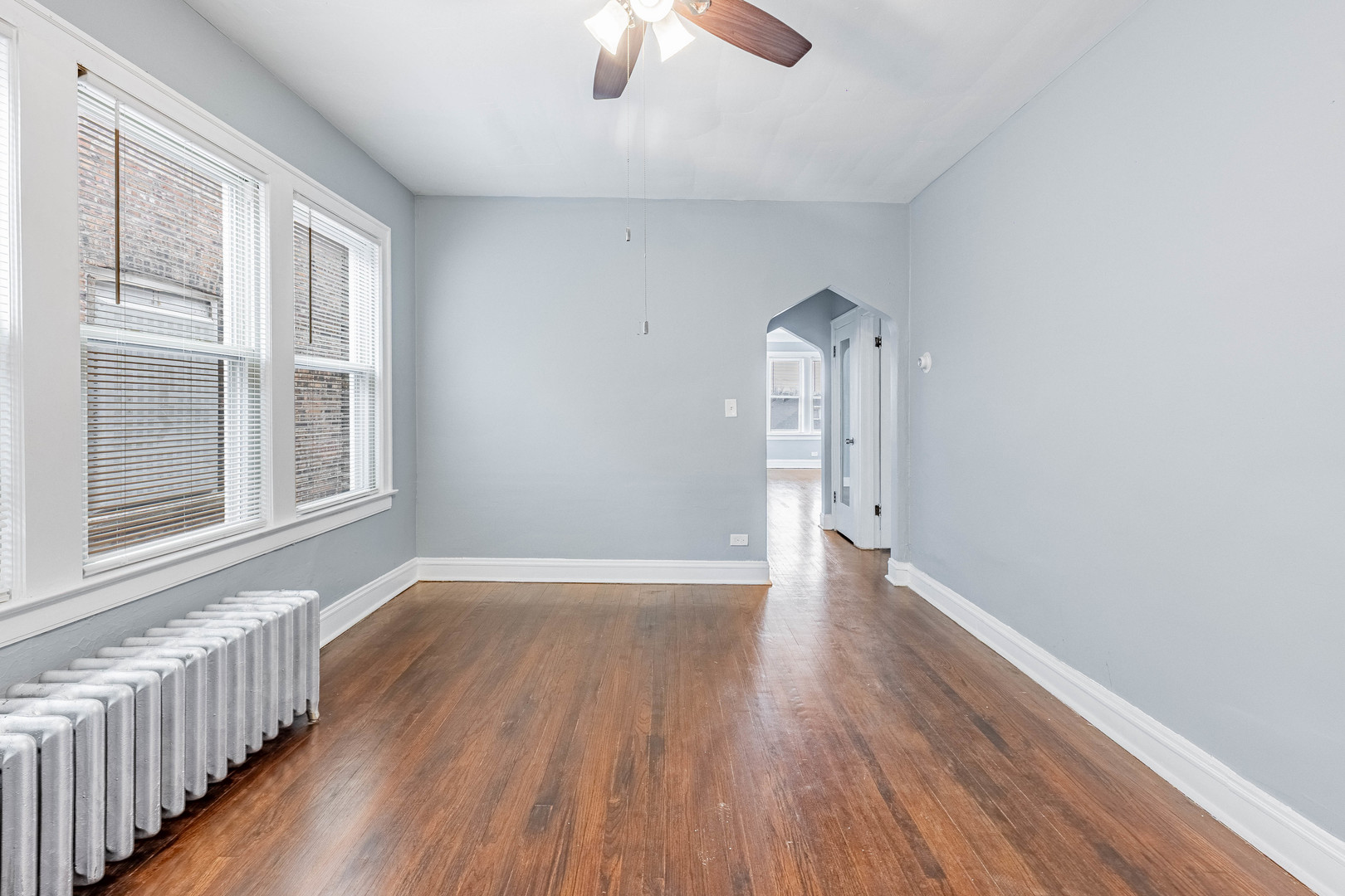 7729 South Laflin Street Chicago, IL 60620 - Photo 10 of 44 wooden floor in an empty room with a window