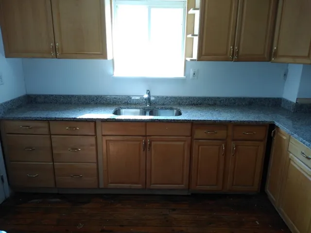a kitchen with stainless steel appliances wooden cabinets and a sink