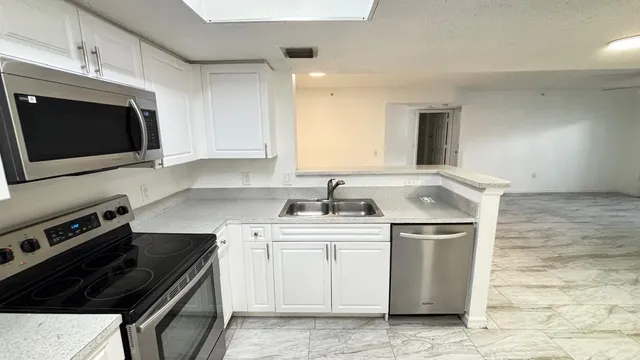 a room with a refrigerator and a sink
